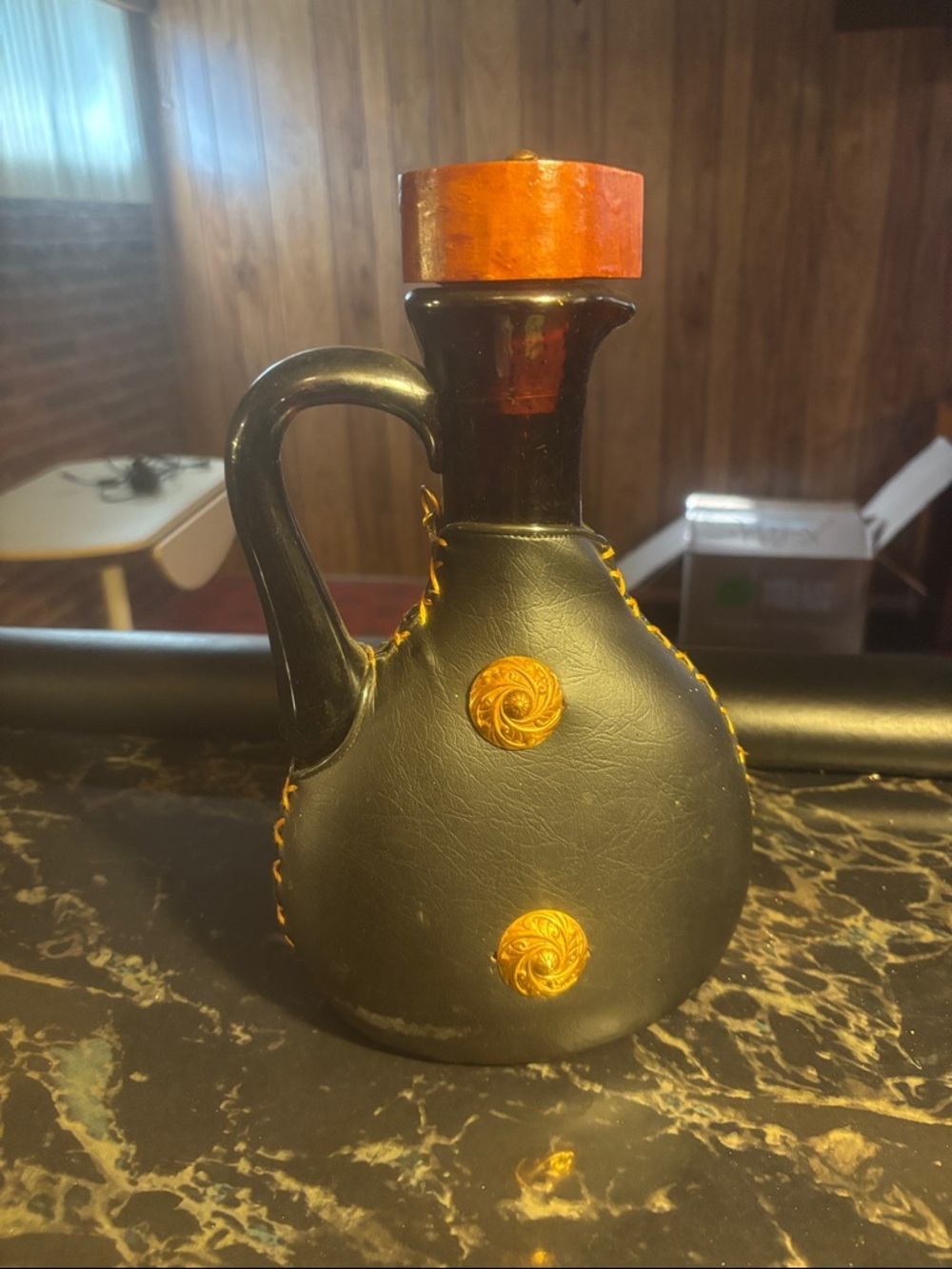 Black Leather-Wrapped Decorative Bottle with Orange Accents